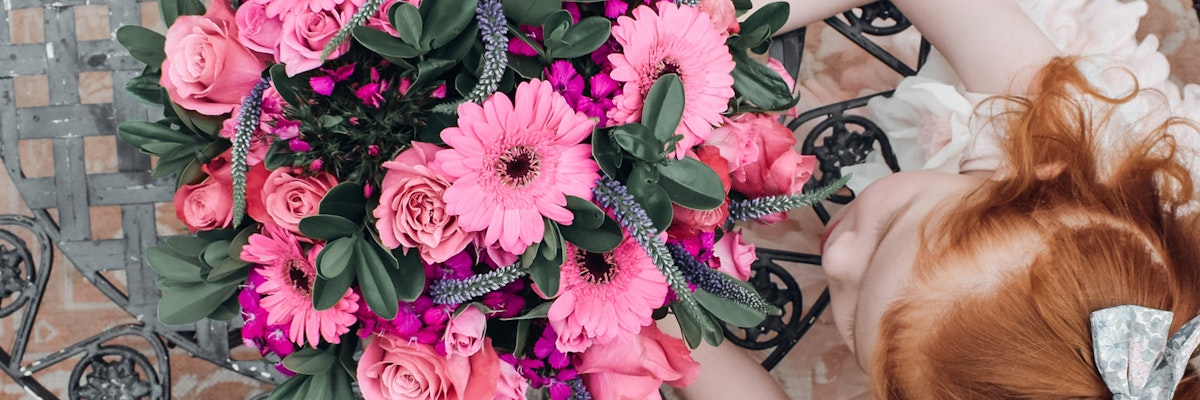 A lovely arrangement of pink flowers including gerbera daisies and roses, perfect for celebrations.