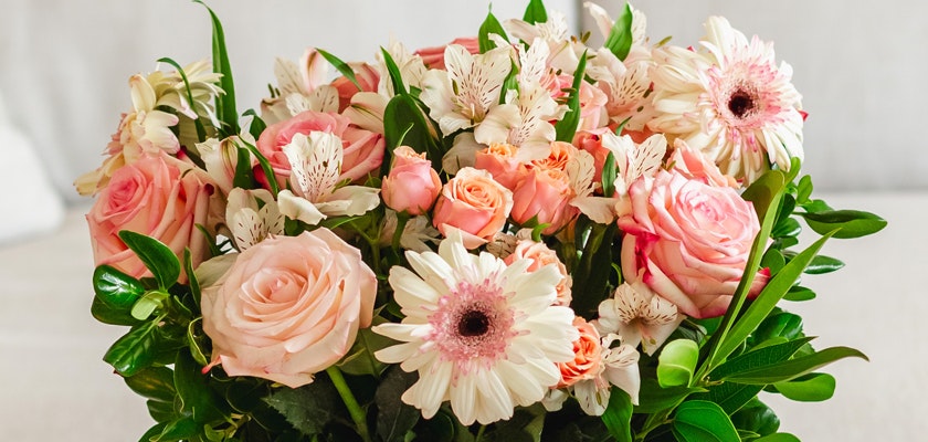 Beautiful floral arrangement featuring blush roses, gerbera daisies, and delicate white blooms.