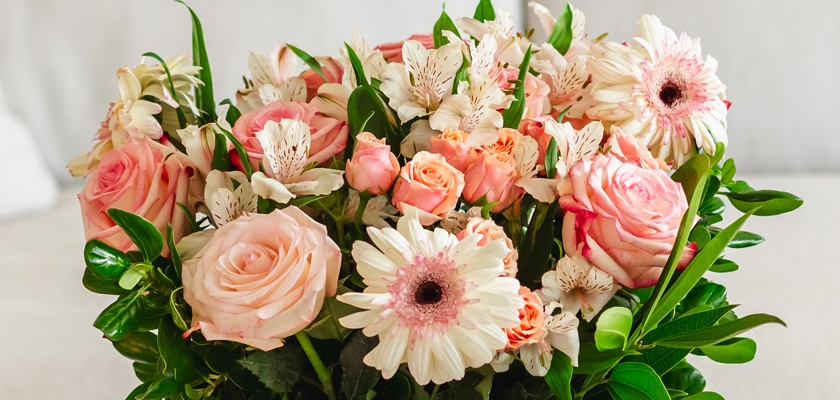 Beautiful floral arrangement featuring blush roses, gerbera daisies, and delicate white blooms.