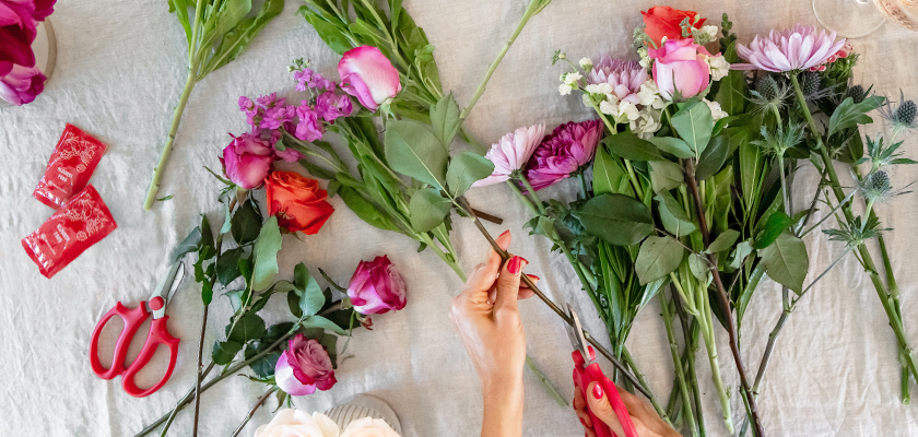 A vibrant assortment of fresh flowers being arranged for a stunning floral display.