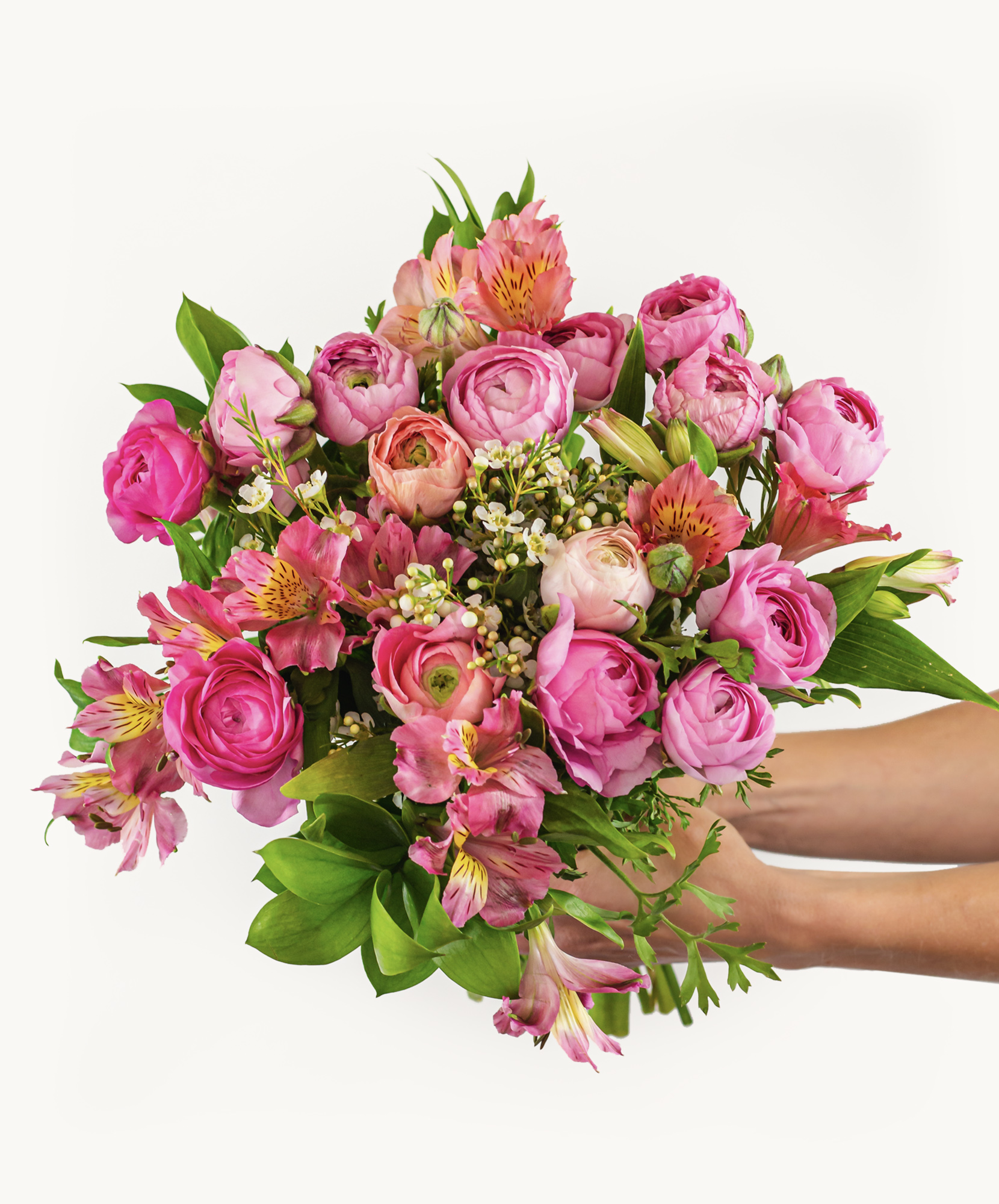 Vibrant bouquet of pink roses and alstroemeria, elegantly held by hands, perfect for celebrations.