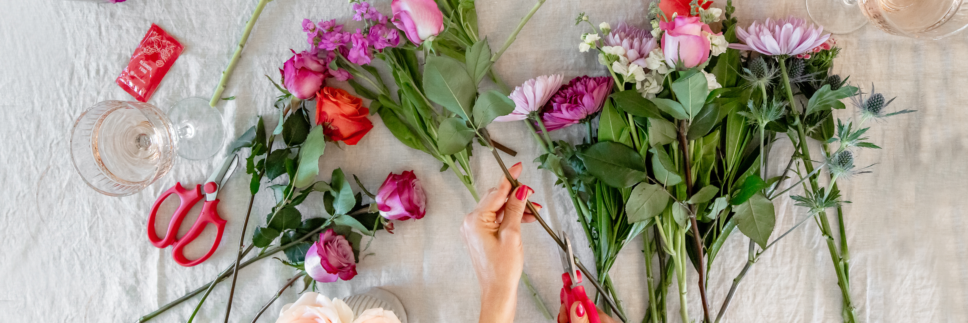 An assortment of vibrant flowers on a table, ready for a stunning floral arrangement.