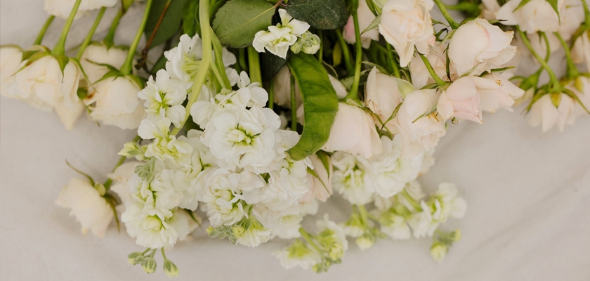 Delicate bouquet featuring soft pink roses and white sweet peas, perfect for elegant occasions.