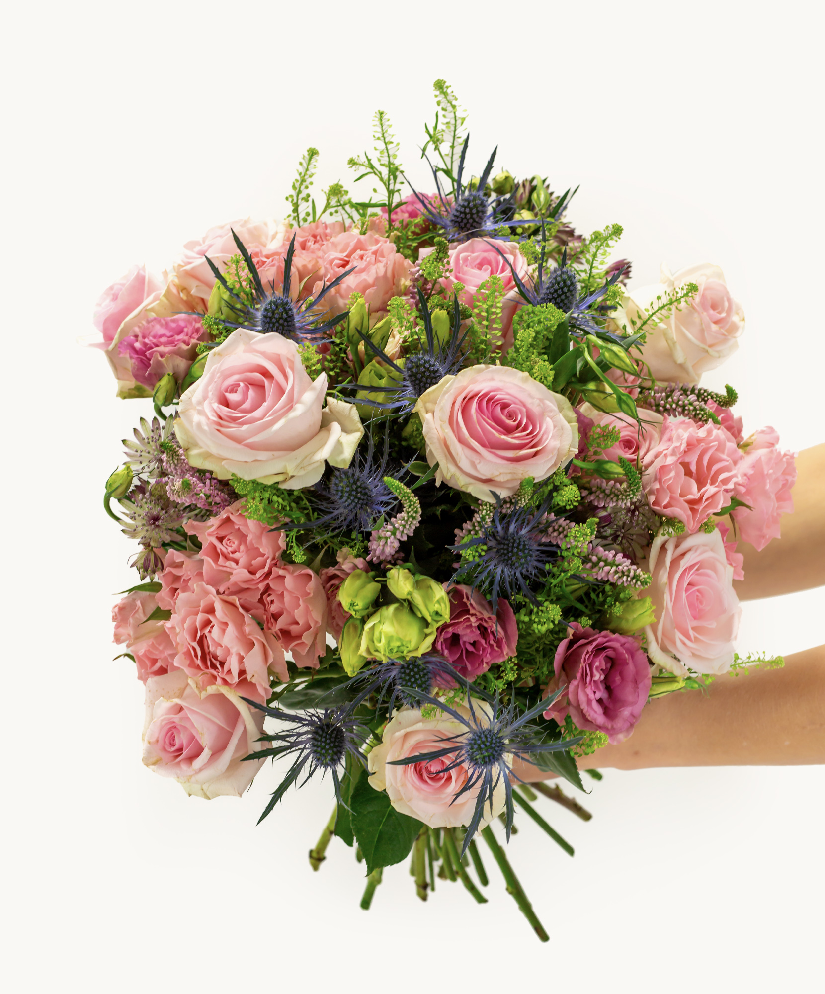 A vibrant floral bouquet featuring pink roses, green accents, and purple blooms, perfect for gifts.