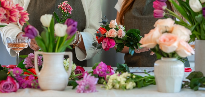 Florists expertly crafting vibrant floral arrangements with fresh blooms and greenery.
