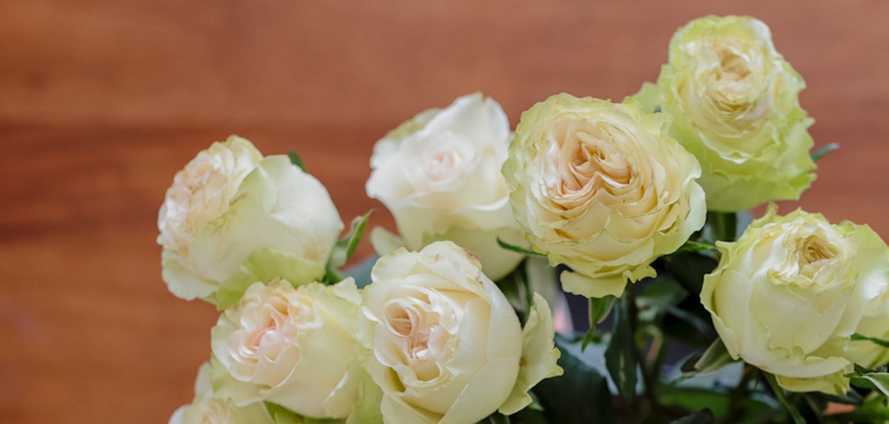 Elegant bouquet of creamy white and soft green roses, perfect for any occasion.