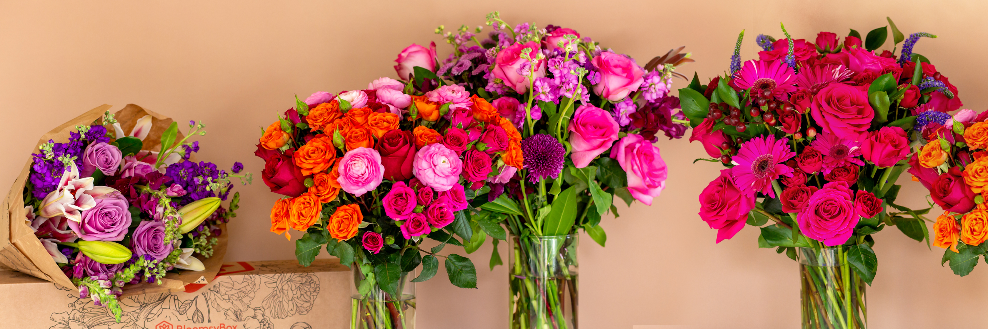 Vibrant flower arrangement featuring roses, lilies, and assorted blooms in stylish vases.