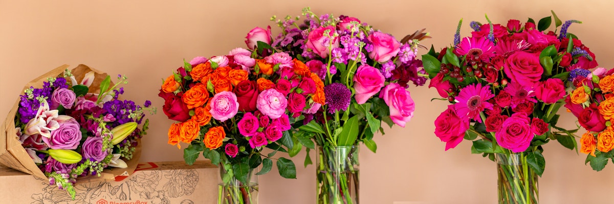 Vibrant flower arrangement featuring roses, lilies, and assorted blooms in stylish vases.