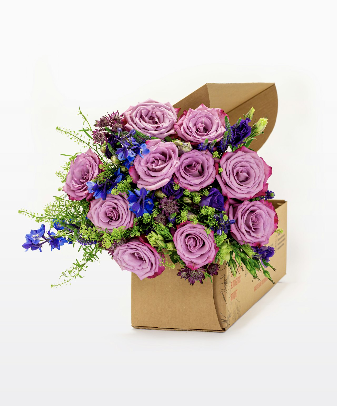 Vibrant bouquet of lavender roses and blue flowers in a stylish floral box, ideal for gifting.