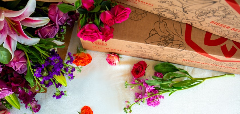 Vibrant floral arrangement featuring roses and lilies, beautifully styled with colorful blooms.