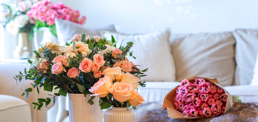 A charming arrangement of pink and peach roses in a stylish vase, enhancing the cozy décor.