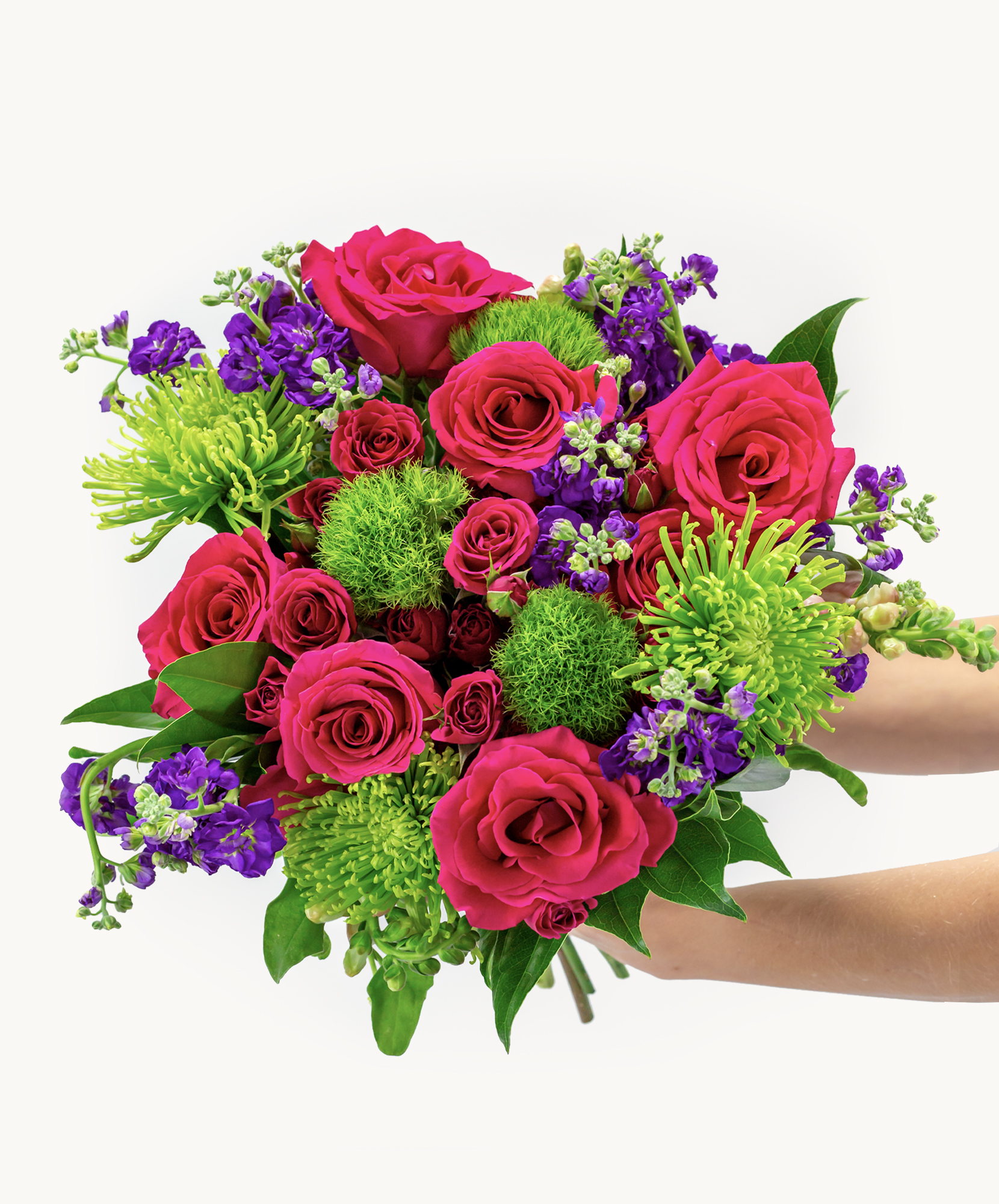 Vibrant bouquet featuring pink roses, purple flowers, and lush greenery, ideal for celebrations.