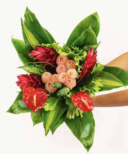Vibrant tropical bouquet featuring red ginger, anthuriums, and lush greenery for a stunning display.