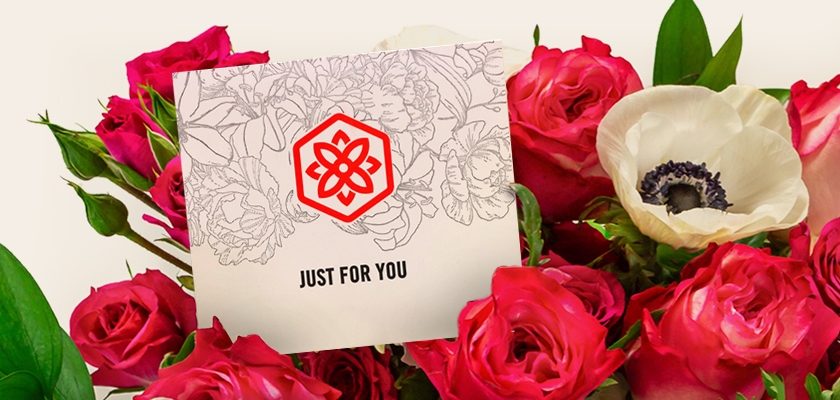 Vibrant floral display featuring pink roses and an elegant card that reads "Just For You."