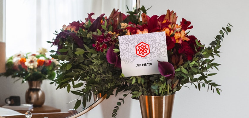 Vibrant flower bouquet with a variety of blooms, accompanied by a stylish card.