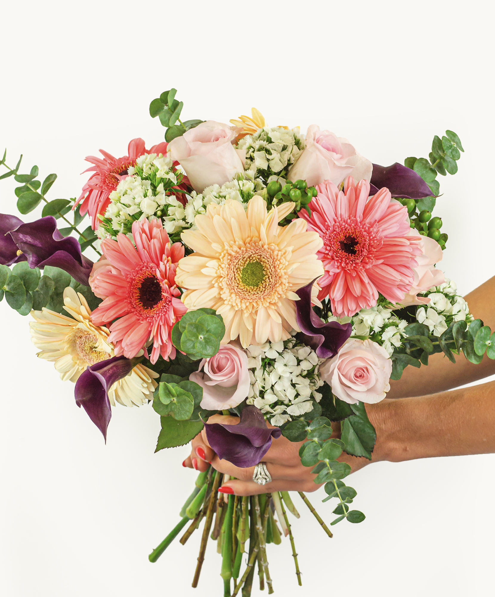Vibrant floral bouquet featuring pink gerbera daisies, roses, and greenery, ideal for celebrations.