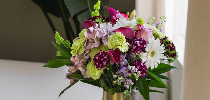 Vibrant floral arrangement featuring pink and purple blooms, ideal for special occasions.