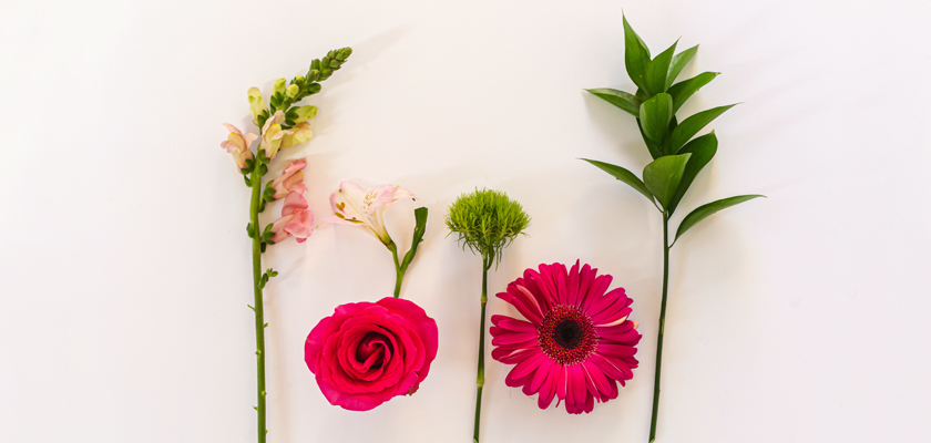 Vibrant floral arrangement featuring pink roses, gerbera daisies, and elegant greenery.