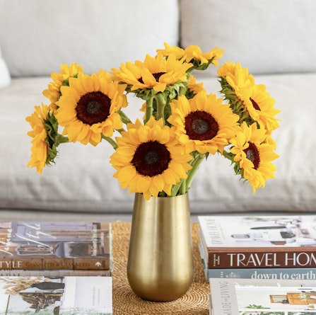 Bright and cheerful sunflower bouquet in a gold vase, adding warmth to any room decor.