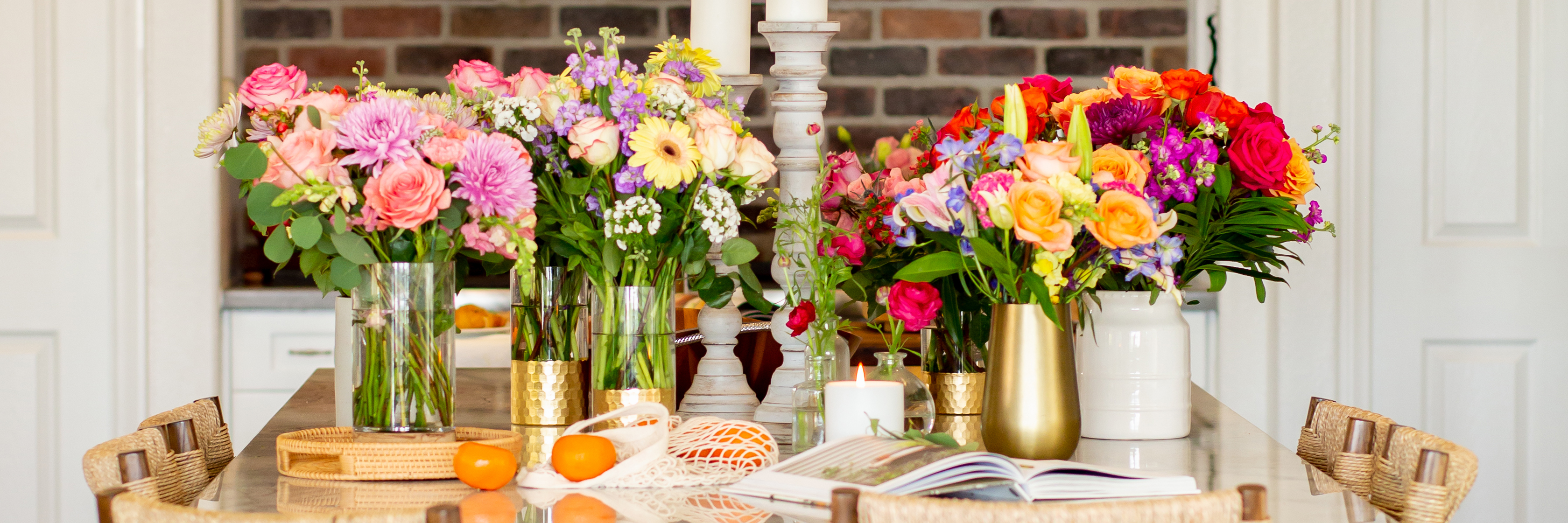 Vibrant floral centerpieces featuring assorted blooms, elegantly arranged on a dining table.