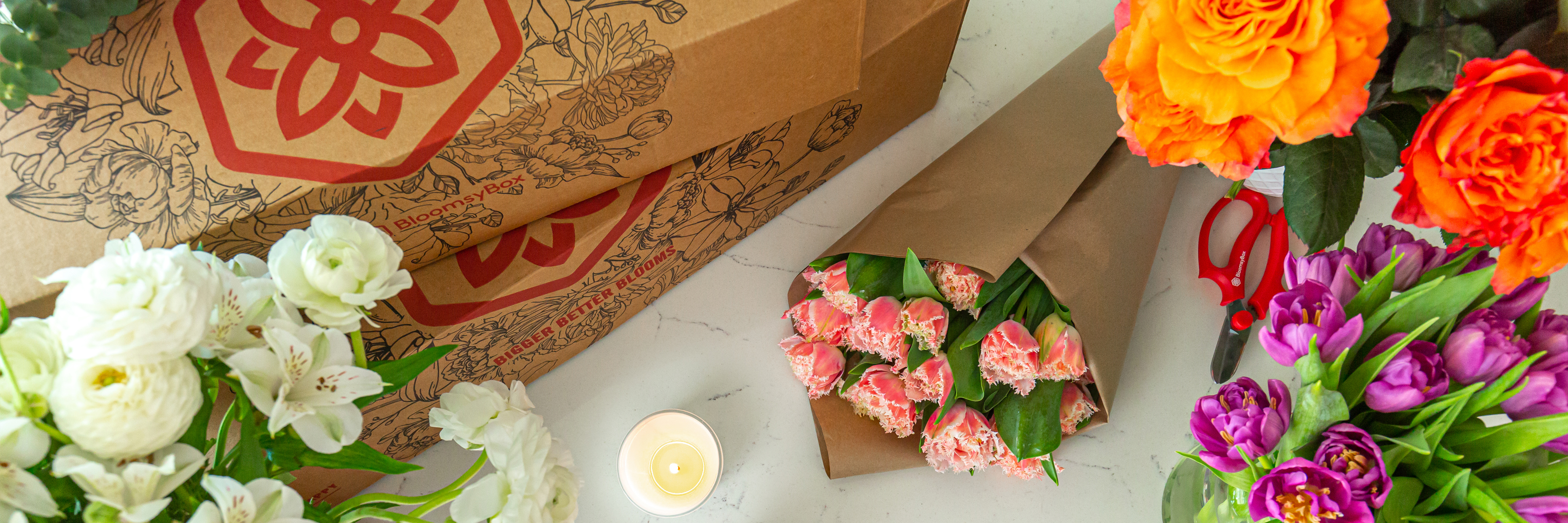Colorful flower arrangements featuring roses, tulips, and carnations in elegant packaging.