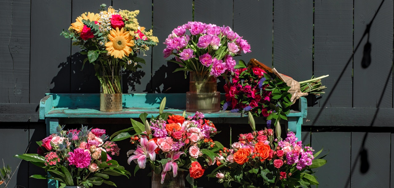 Vibrant flower display featuring mixed blooms in colorful arrangements, ideal for any celebration.