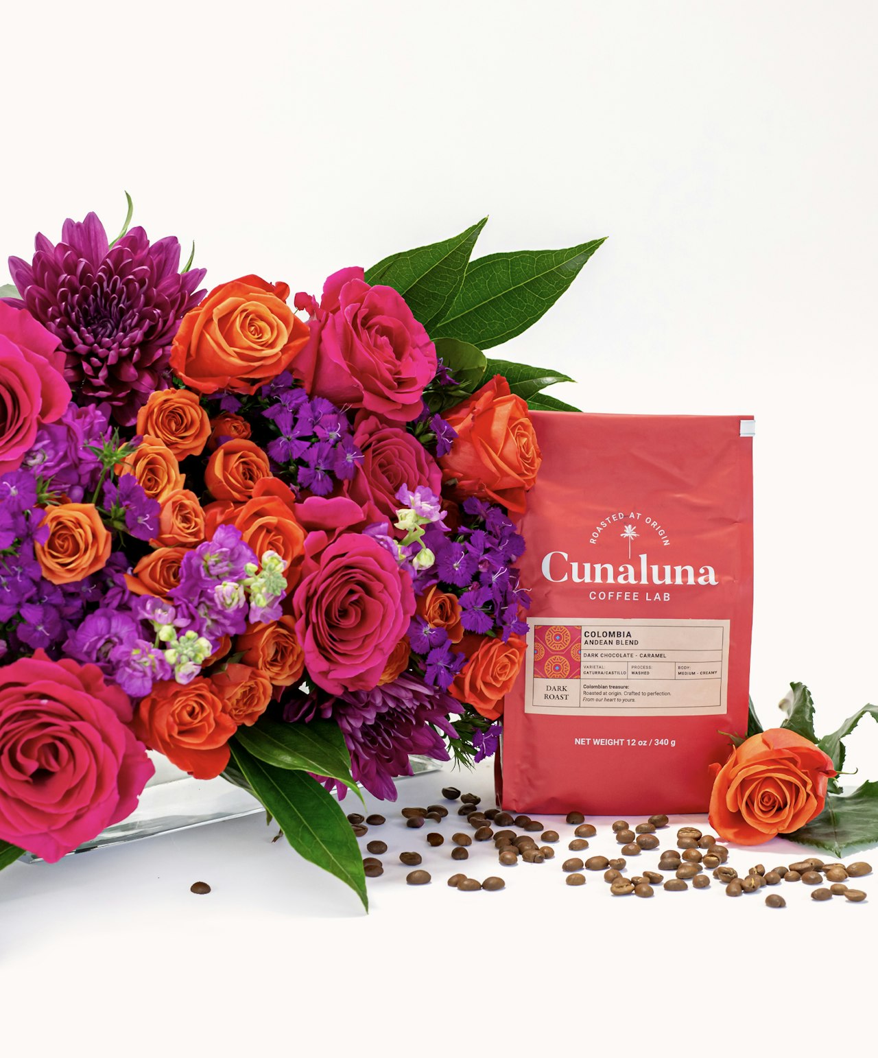 Vibrant floral arrangement with pink, orange, and purple blooms beside Cunaluna coffee bag.