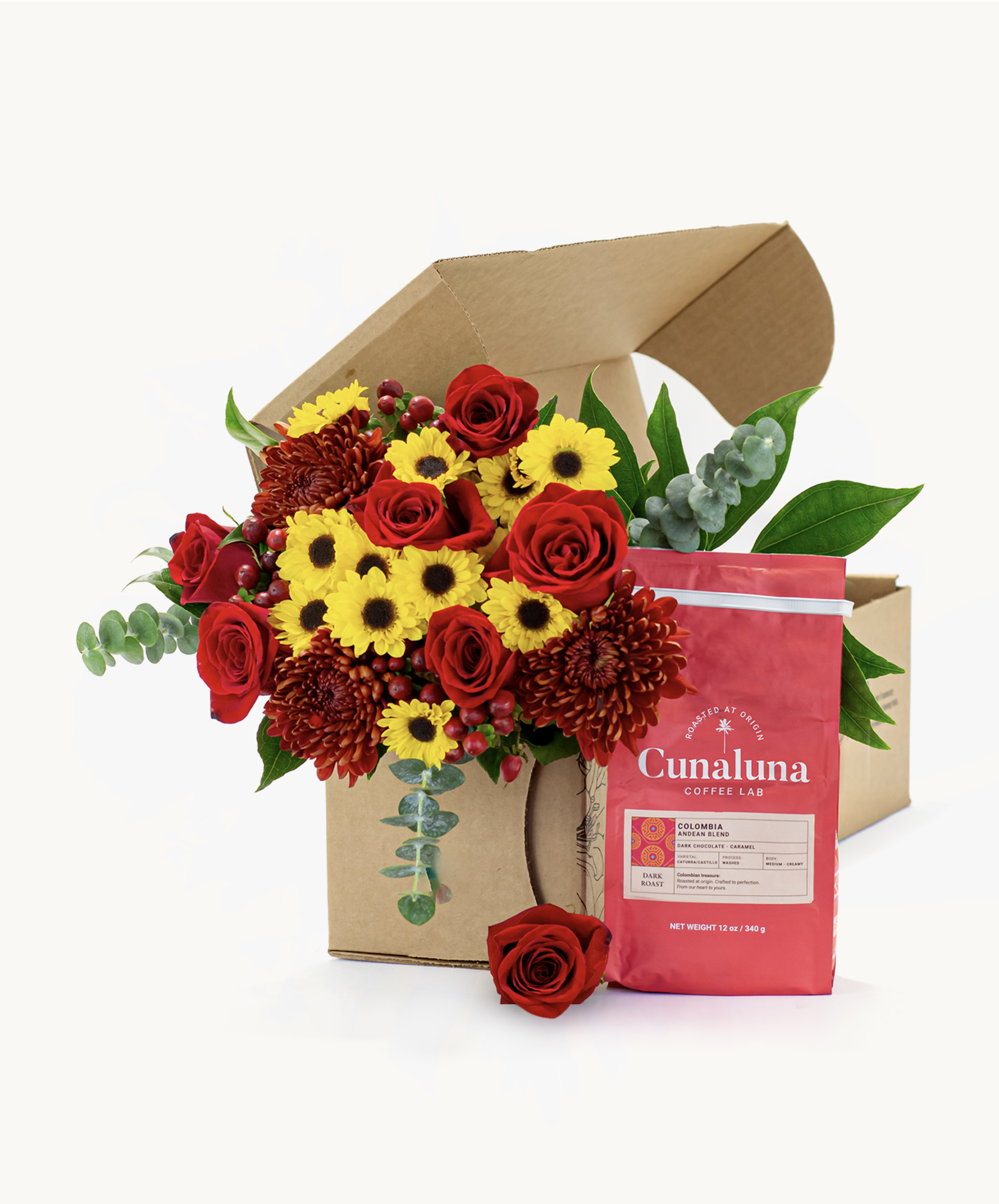 Vibrant floral arrangement with red roses and cheerful yellow daisies, paired with gourmet coffee.
