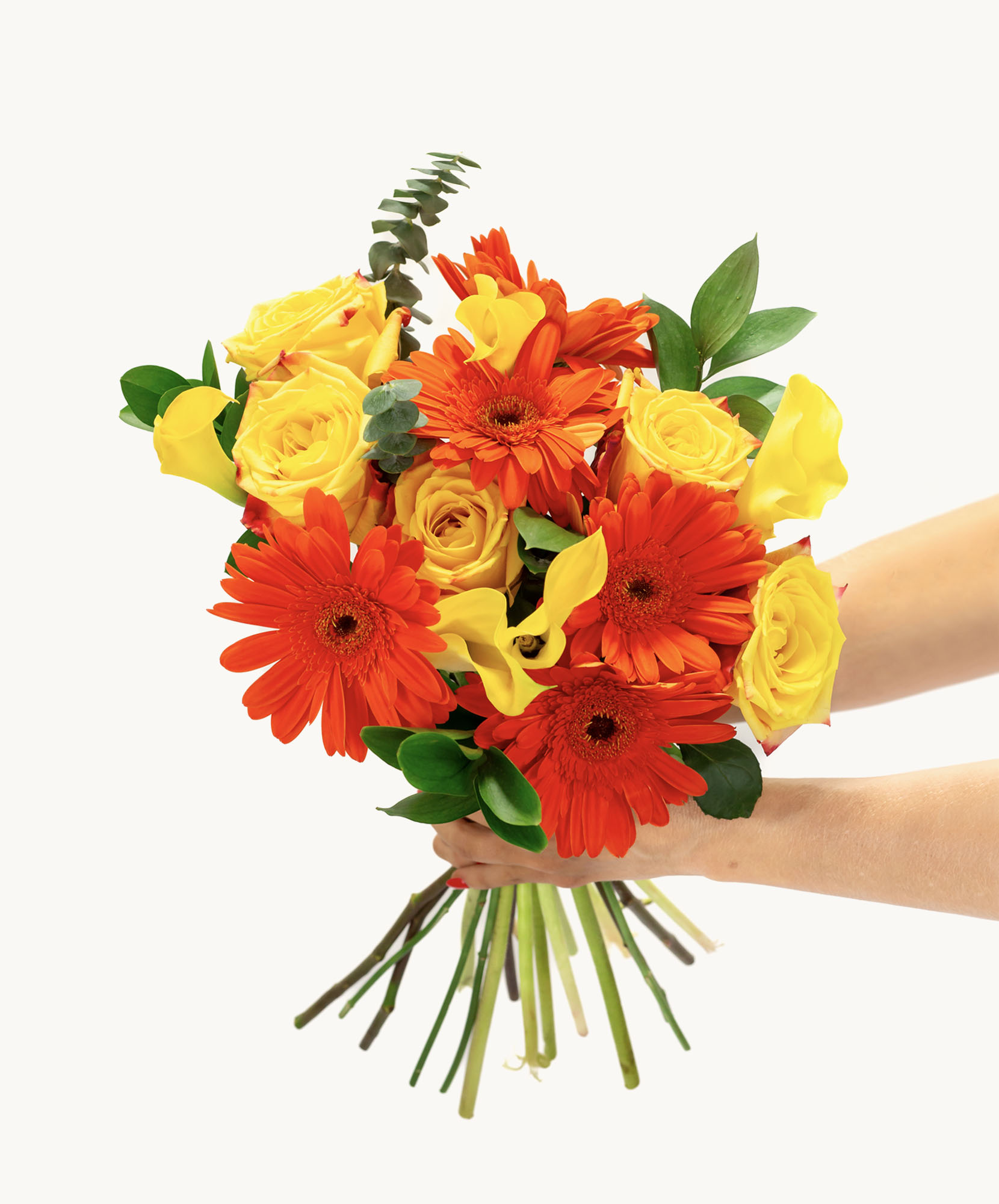 Vibrant bouquet featuring orange gerbera daisies and yellow roses, elegantly held.