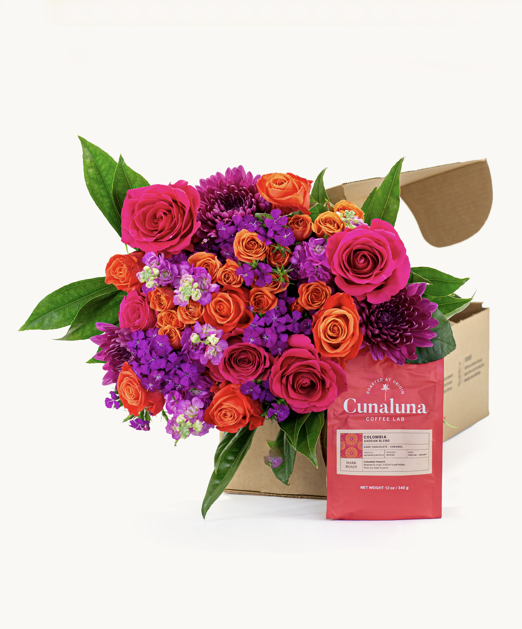 Vibrant flower bouquet featuring pink, purple, and orange roses beside a coffee bag.