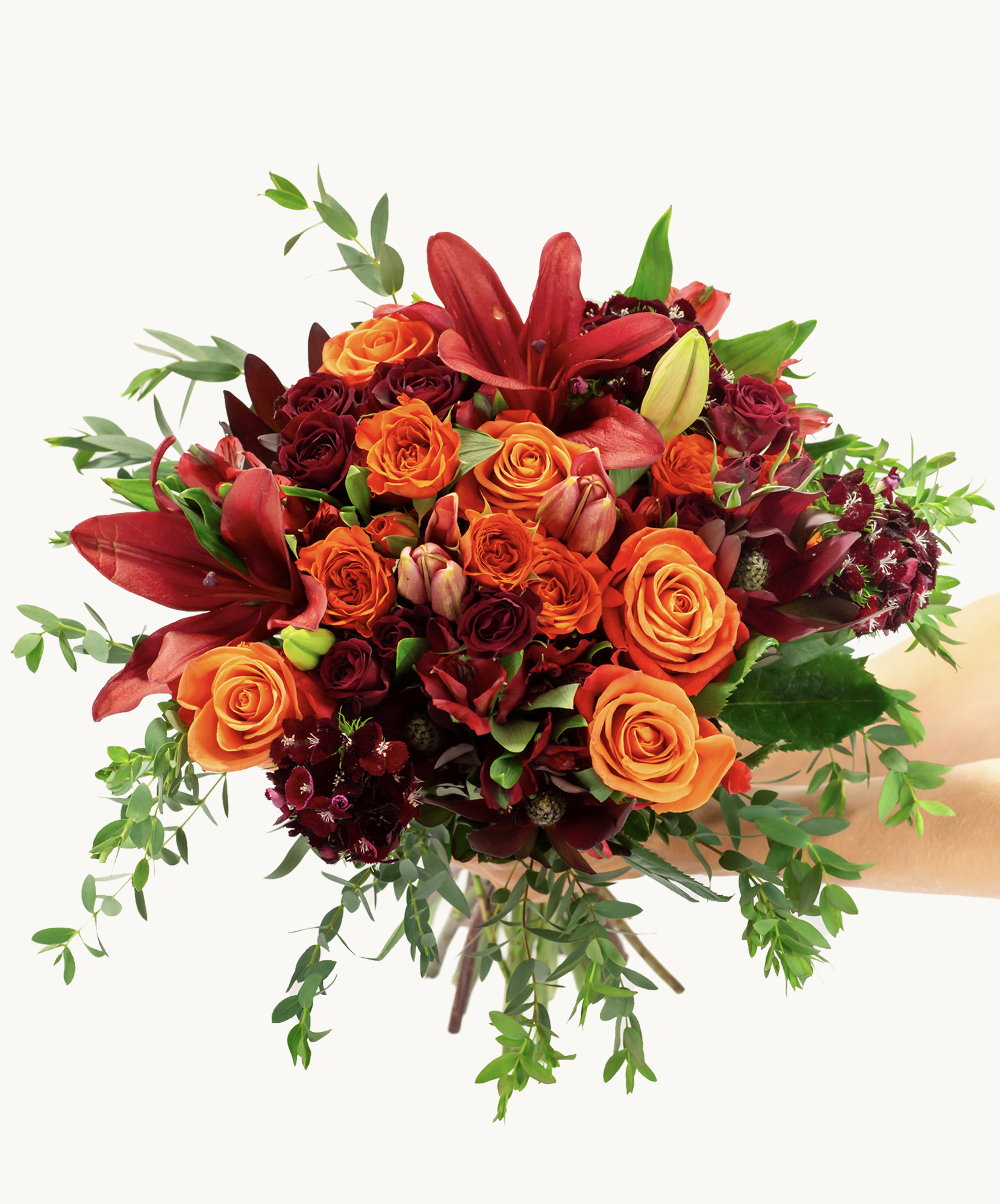 Vibrant bouquet of orange and red roses with lush greenery, perfect for celebrations and gifting.