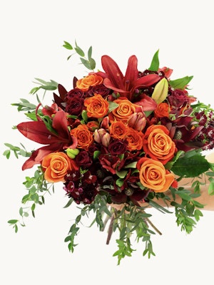 Vibrant bouquet of orange and red roses with lush greenery, perfect for celebrations and gifting.