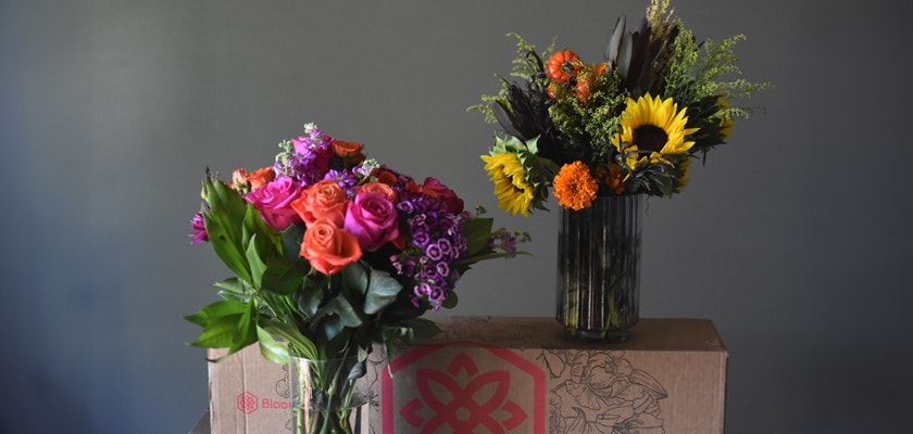 Vibrant flower arrangements featuring roses and sunflowers in elegant vases on display.