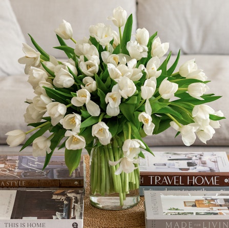 Elegant bouquet of white tulips in a glass vase, perfect for home decor or gifting.