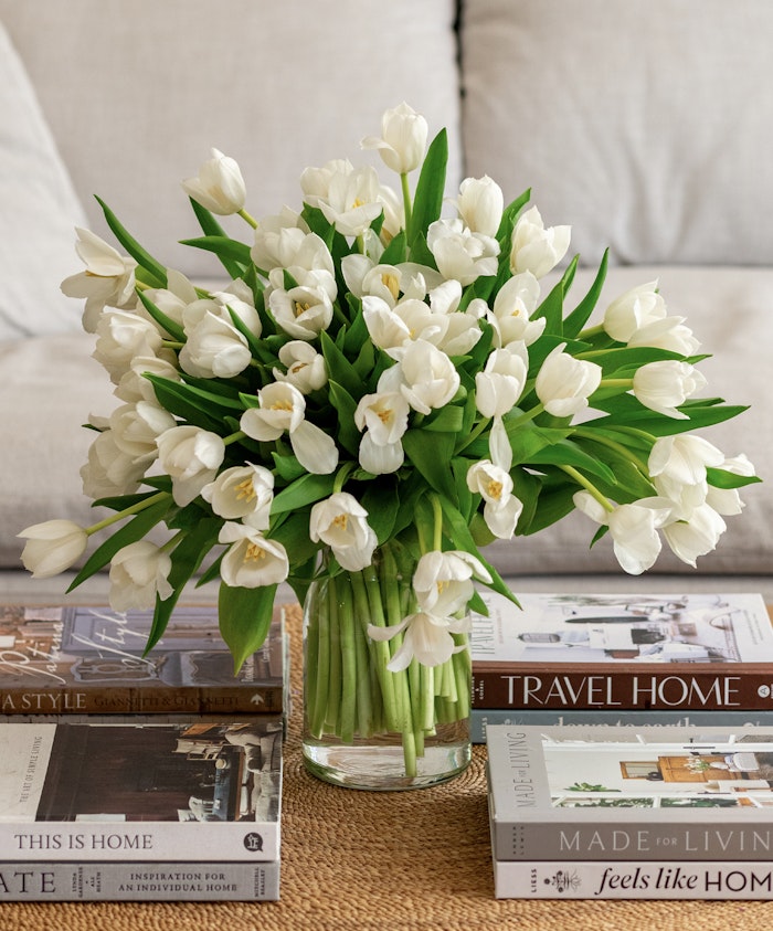 Elegant bouquet of white tulips in a glass vase, perfect for home decor or gifting.