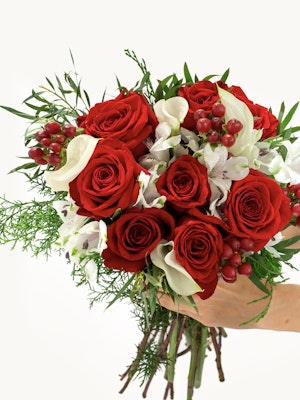 Vibrant bouquet featuring red roses, white flowers, and lush greenery, perfect for any celebration.