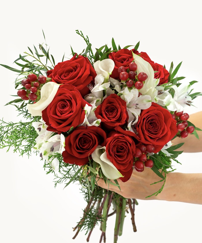 Vibrant bouquet featuring red roses, white flowers, and lush greenery, perfect for any celebration.
