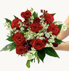 Vibrant red roses paired with white blossoms and green foliage, ideal for any celebration.