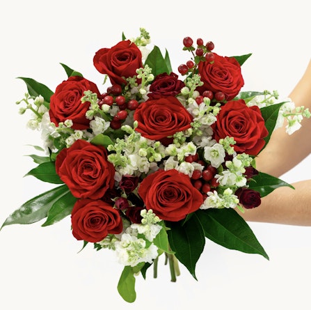 Vibrant red roses paired with white blossoms and green foliage, ideal for any celebration.