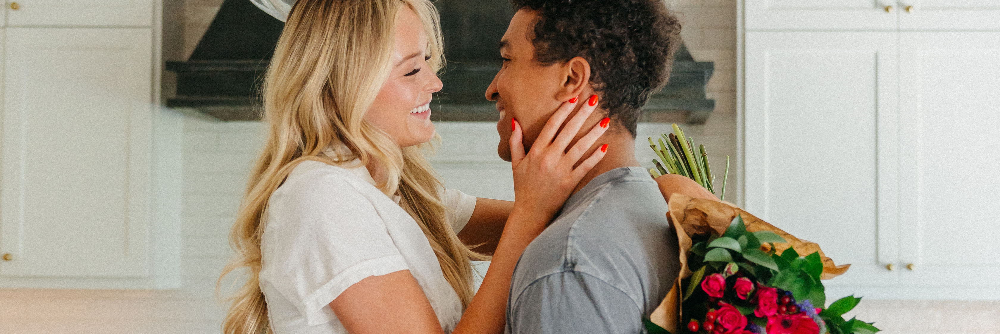 A joyful couple sharing a loving moment, surrounded by a beautiful bouquet of flowers.