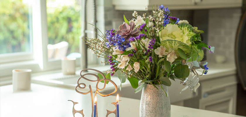 A charming floral arrangement featuring mixed blooms in a rustic vase, perfect for home decor.