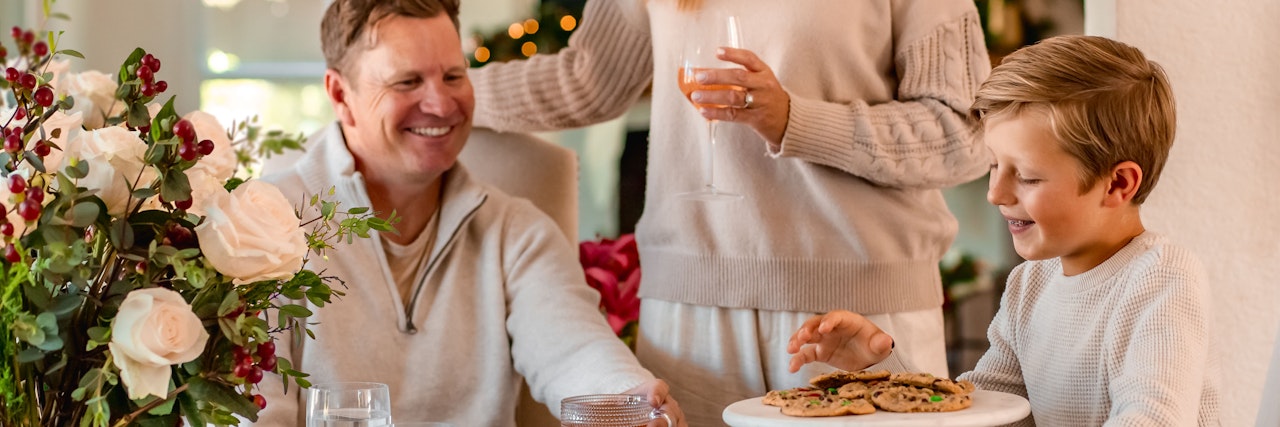 A joyful family moment with a festive table, sharing cookies and laughter together.