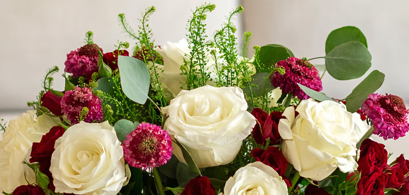 Elegant bouquet featuring white roses, red roses, and lush greenery for special occasions.