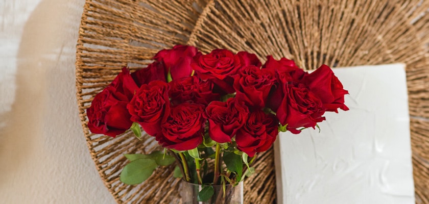Vibrant bouquet of red roses elegantly displayed in a glass vase, enhancing any room's decor.