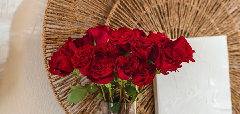 Vibrant bouquet of red roses elegantly displayed in a glass vase, enhancing any room's decor.