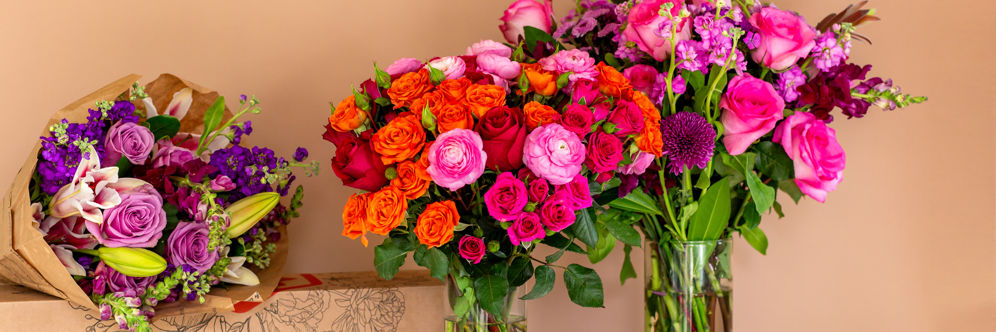 Vibrant floral display featuring colorful roses and mixed blooms in elegant vases.