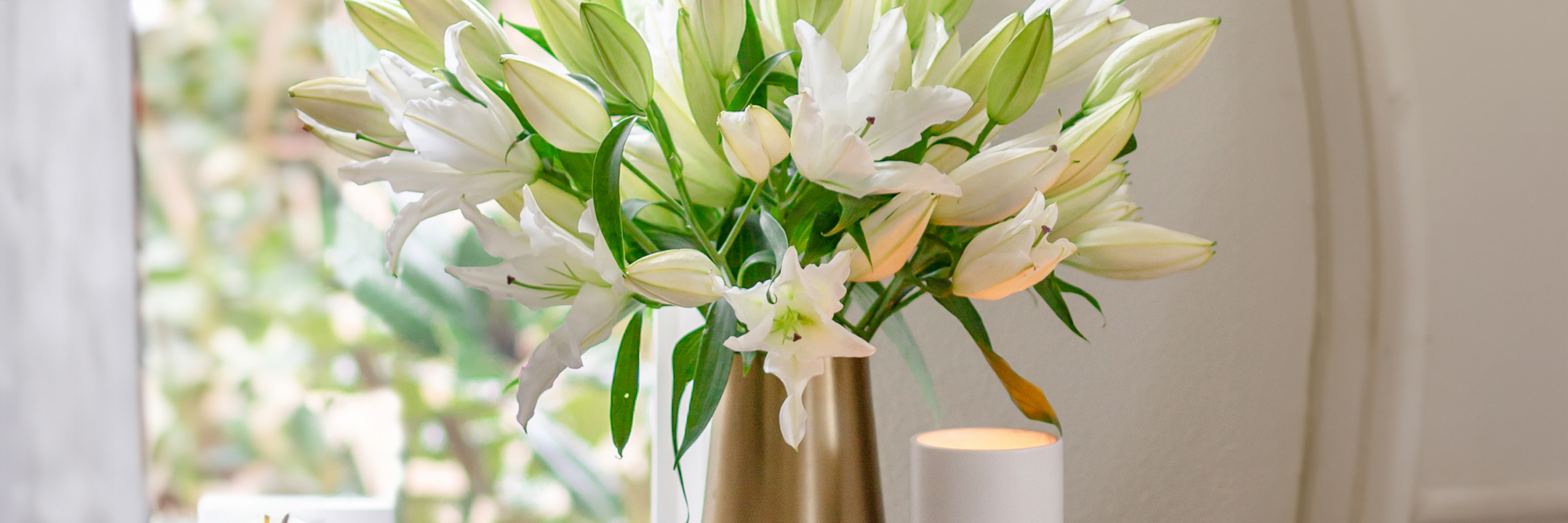 Elegant white lilies in a chic vase, creating a serene and bright floral centerpiece.