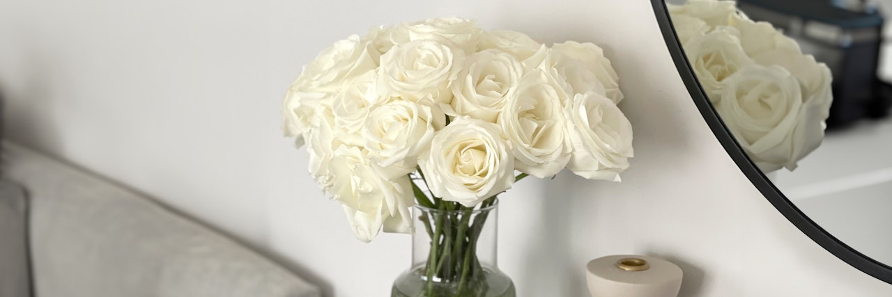 Elegant white roses in a glass vase, adding a touch of sophistication to any modern interior decor.