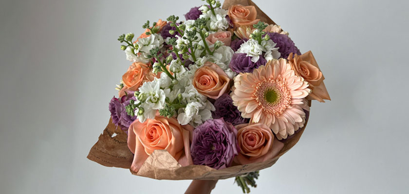 Beauty of pastel flowers featuring gerbera daisies, roses, and snapdragons in a charming bouquet.