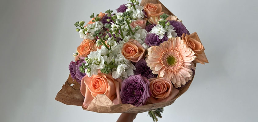 Beauty of pastel flowers featuring gerbera daisies, roses, and snapdragons in a charming bouquet.